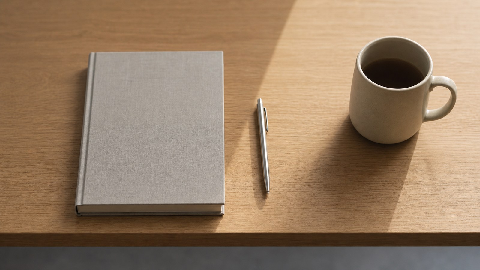 Closed notebook and pen on a simple table representing clear boundaries